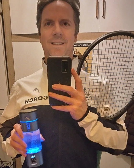 James Mottershead, tennis coach, holding his Nord Hydrogen Bottle and racket